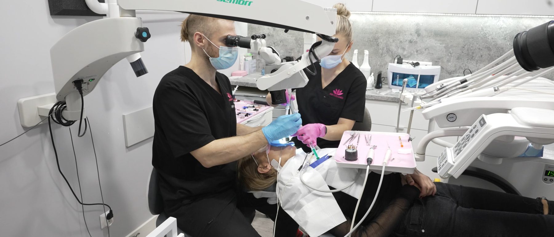 Bartosz Szczepanik and his assistant working 4-handed under the microscope